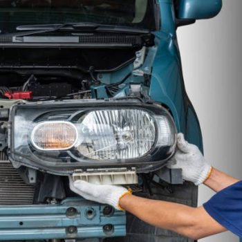 Maintenance technician is removing the car headlights